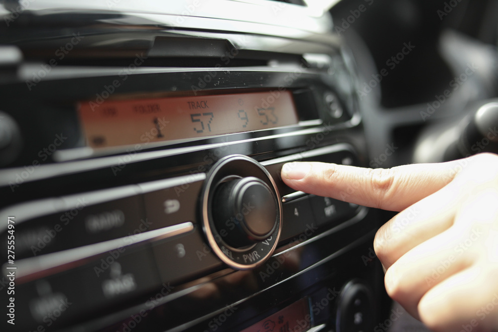 Driver's Hand Press Button on Car Radio
