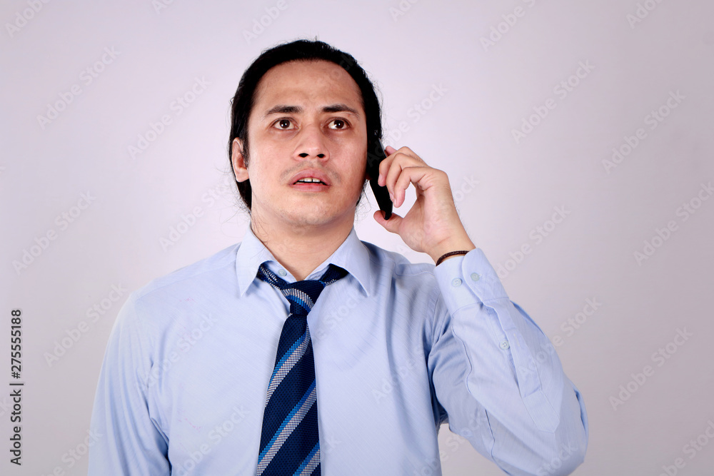 Young Man Talking on Phone, Shocked Worried Expression Young Man Talking on Phone, Shocked Worried Expression