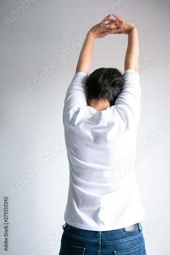 Wallpaper Mural Back of woman stretching arms over head for stretch muscle and exercise. Torontodigital.ca