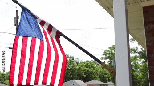 American flag hanging from the front of house photo