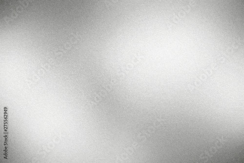 Glowing rough silver metallic plate, abstract texture background
