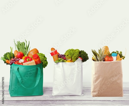 Full shopping bags on wood tablet and window background