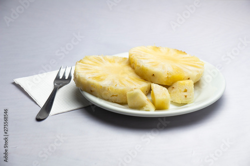 a plate with slices of pineapple
