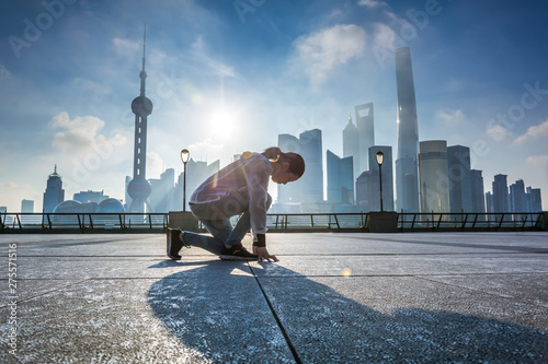 Woman running at Shanghai bund in the morning,landmark of Shanghai photo