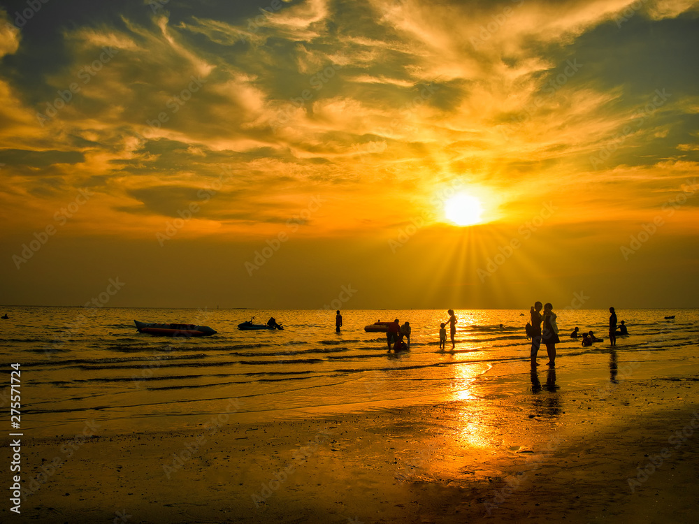 Silhouettes  of young group and children group are happy on the beach during the sunset.Summer time concept.