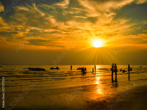 Silhouettes of young group and children group are happy on the beach during the sunset.Summer time concept.