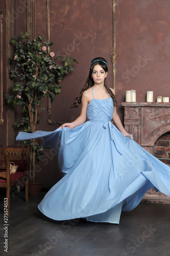 Obraz na plátně Young girl spinning in a dress