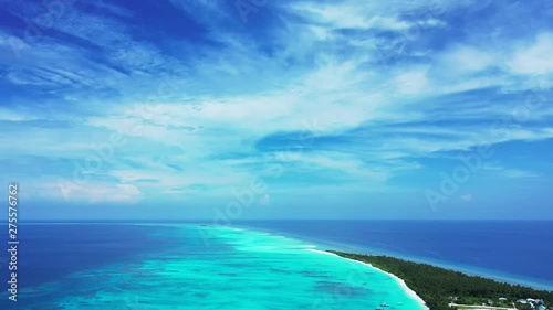 Wallpaper Mural Aerial view from high above on a tropical island with palm trees and some buildings on it. Turquoise water of the Philippines under a blue sky with clouds. Pan left Torontodigital.ca