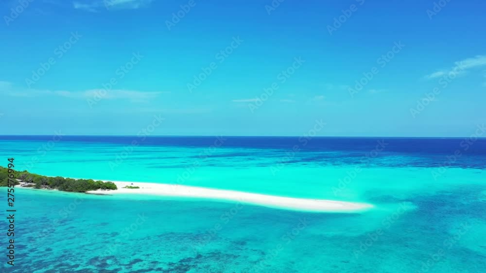 Fly towards a long island with a sandy beach at its end. Surrounded by the turquoise sea in Hawaii, a blue sky above. Fly towards a long island with a sandy beach at its end. Surrounded by the turquoise sea in Hawaii, a blue sky above.