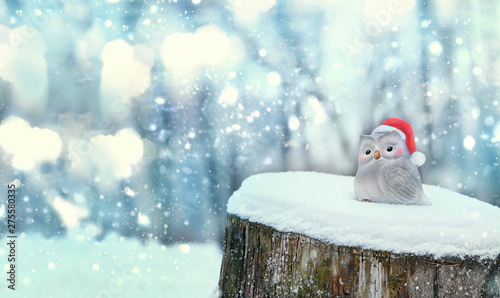 Merry Christmas and happy new year holiday concept. Christmas toy bird on snow wood. cute little bird toy on winter background. festive winter still life. banner. copy spase