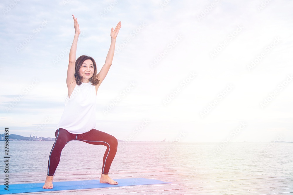 Woman is exercising at pier by the seaside Woman is exercising at pier by the seaside