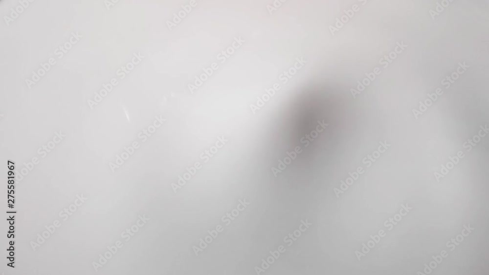 the texture of the surface of the milk, poured into a bowl. slow motion the texture of the surface of the milk, poured into a bowl. slow motion