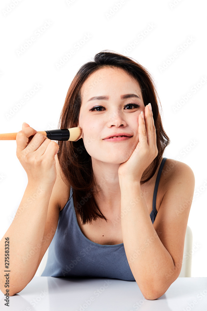 studio shot young woman applying make-up studio shot young woman applying make-up