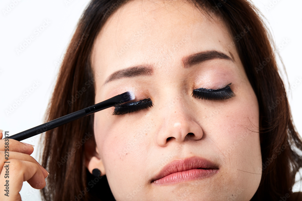woman applying make-up cosmetic woman applying make-up cosmetic
