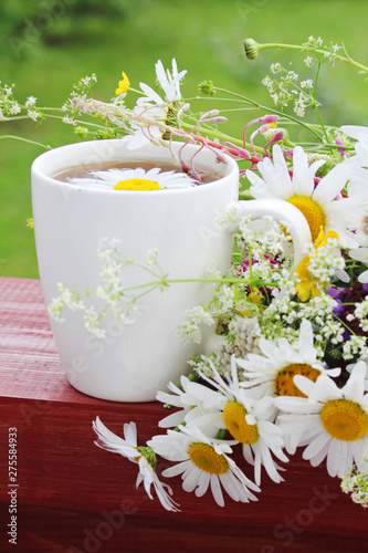 A cup with floral natural chamomile tea