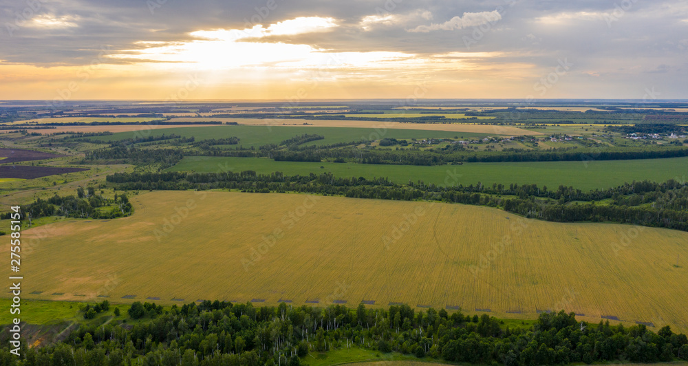 Views of the ravines, the fields with the quadcopter in the rays of the setting sun