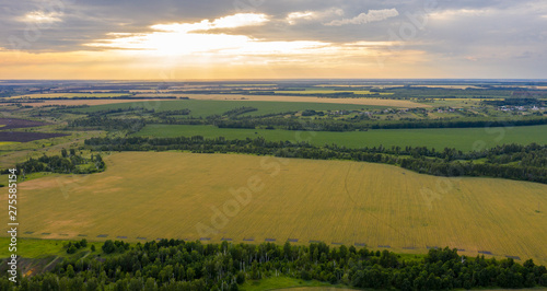 Views of the ravines, the fields with the quadcopter in the rays of the setting sun