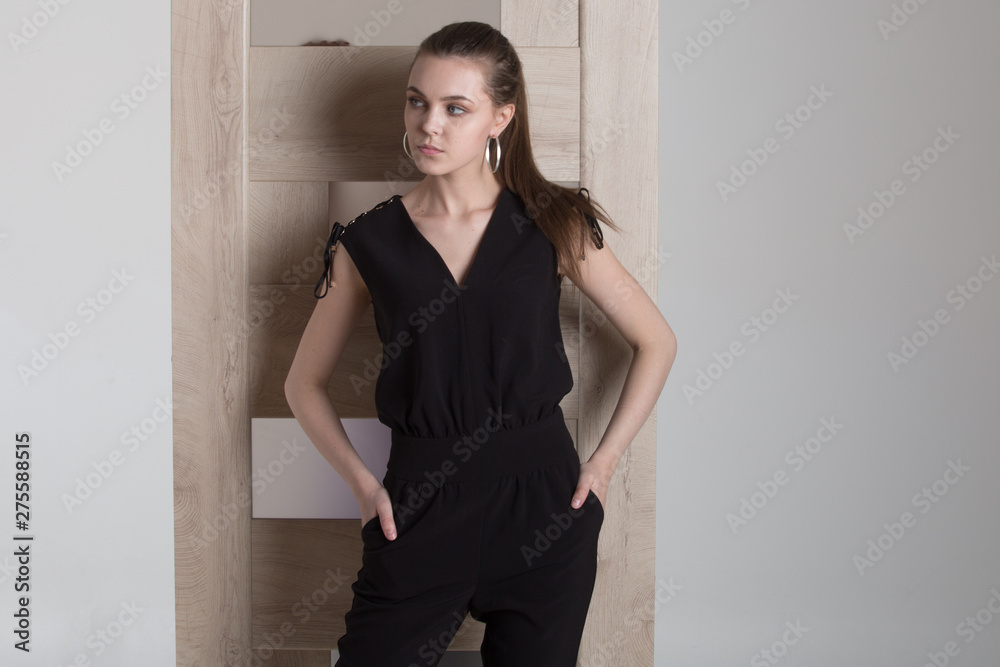 Beautiful woman peeking from behind the white door, isolated on white background with copy space Beautiful woman peeking from behind the white door, isolated on white background with copy space