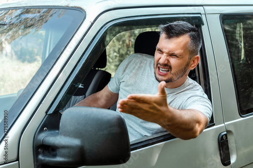 Aggressive Man, the driver of the car is outraged at the wheel during the trip. Emergency, accident, violation of rights, dispute, bad driver