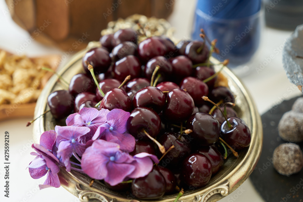 Fresh cherries in wooden bowl on table, close-up. healthy snack food 