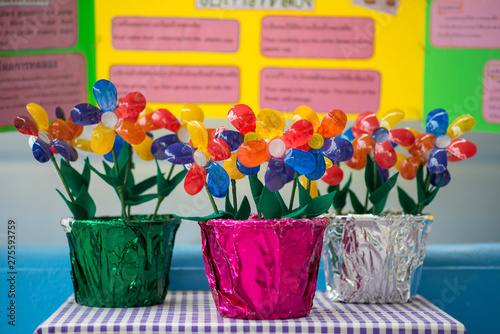 Recycled colorful plastic flowers in pot.Recycle decoration.