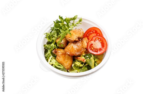 Isolated cooked dish with chicken and greens and tomatoes in white plastic container.