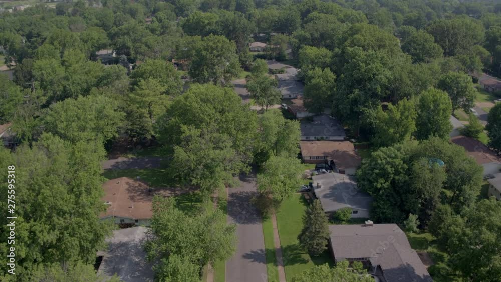 aerial flyover suburbs and streets with cars driving across frame aerial flyover suburbs and streets with cars driving across frame