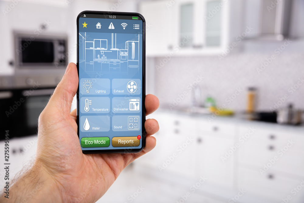 Fotografie Hand Holding Mobile With Smart Home Control Icon Feature