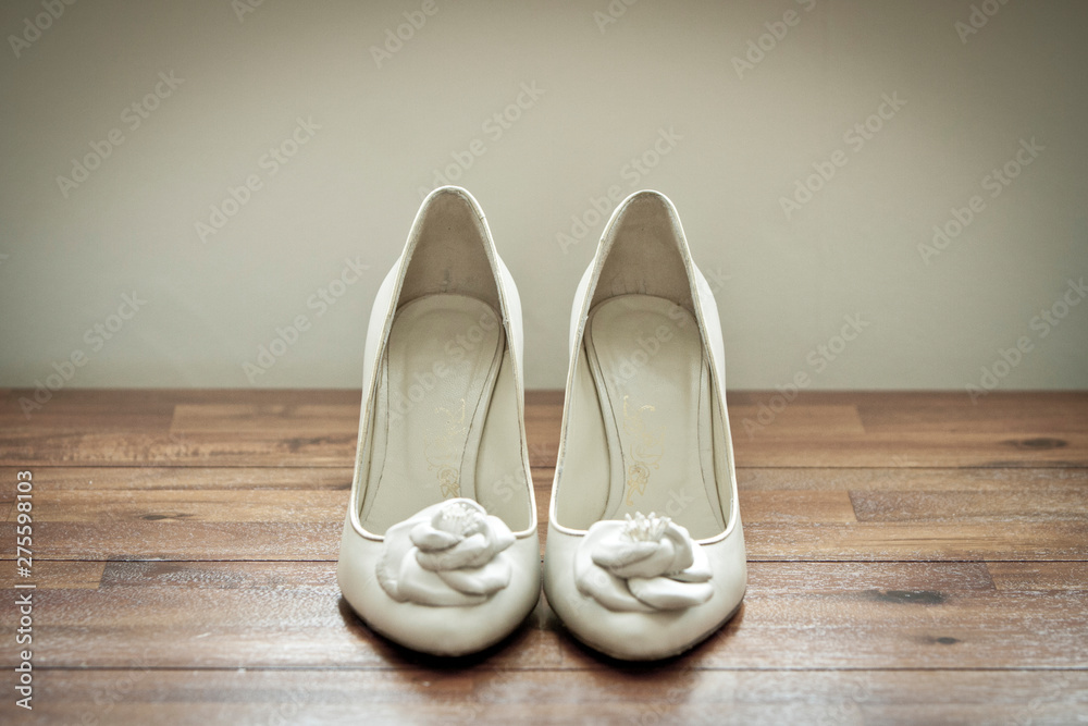 Bridal wedding shoes on wooden background Bridal wedding shoes on wooden background