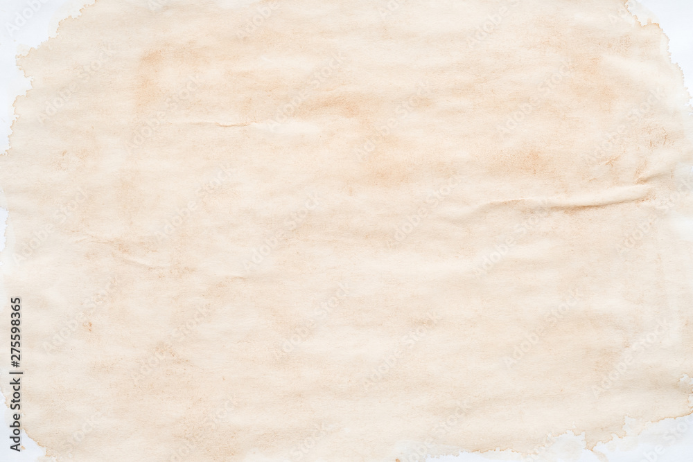 Beige splotch over white surface. Stained paper effect abstract art background. Copy space.