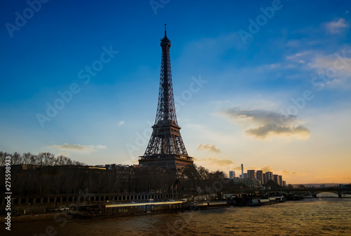 Panaramic view of the Eiffel tower and Seine river in the sunset sky scene.
