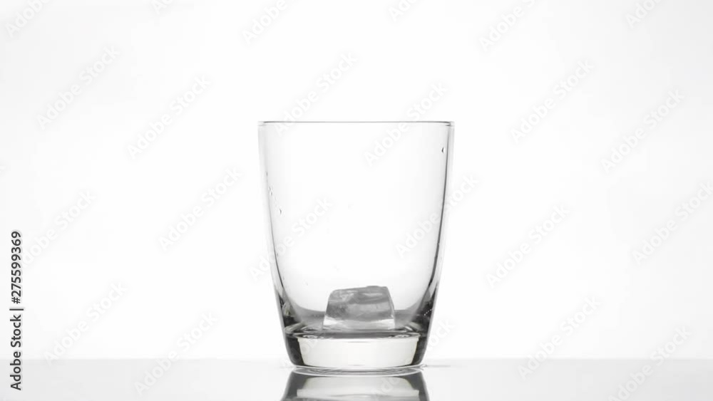 Pouring cola with ice and bubbles in a glass, Slow motion Pouring cola with ice and bubbles in a glass, Slow motion