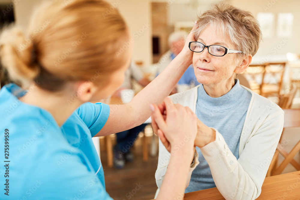 Fototapeta premium Caregiver consoles seniors with dementia