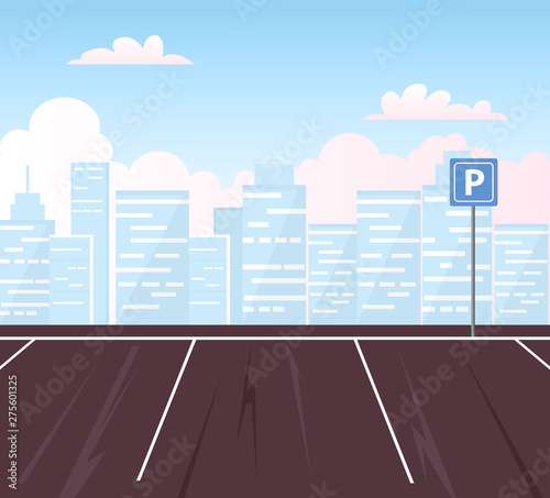 Empty parking lot with city in the background