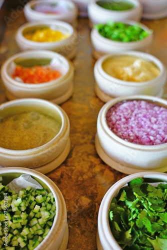 Mise en place of little dishes with ingredients for making tropical ceviche photo