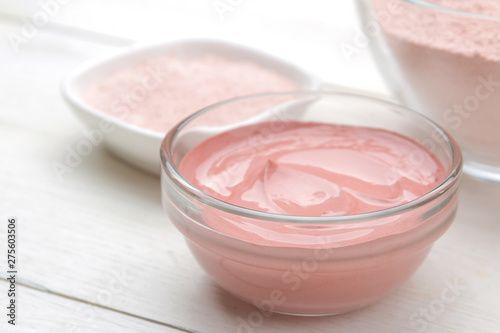 Cosmetic clay. Pink cosmetic clay in different types on a white wooden table. face mask and body. care products. spa.