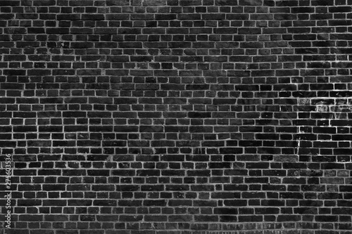 Old vintage black brick wall texture for background  wide panoramic backdrop