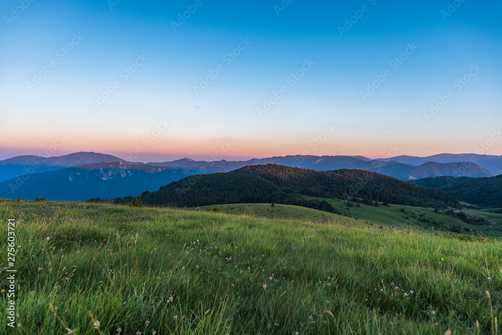 Amazing mountain landscape with colorful vivid sunset on clear sky, natural outdoor travel background