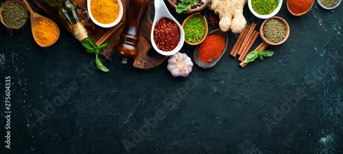Panel kuchenny z motywem Colorful herbs and spices for cooking. Indian spices. On a black stone background. Top view.