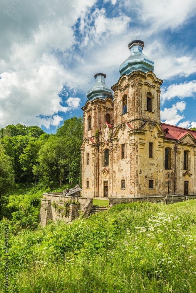 Skoky, Zlutice / Czech Republic - June 21 2019: Baroque church of the Virgin Mary Visitation in Skoky, Maria Stock, is a former pilgrimage place in West Bohemia. Sunny day, blue sky with clouds.