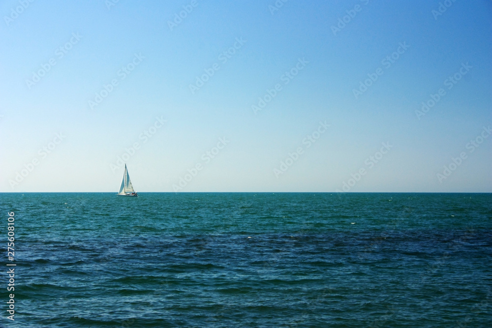 Lonely sail in the sea on the horizon