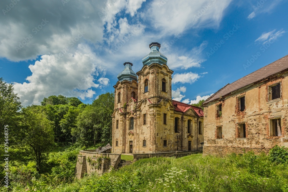 Skoky, Zlutice / Czech Republic - June 21 2019: Baroque church of the Virgin Mary Visitation in Skoky, Maria Stock, is a former pilgrimage place in West Bohemia. Sunny day, blue sky with clouds.