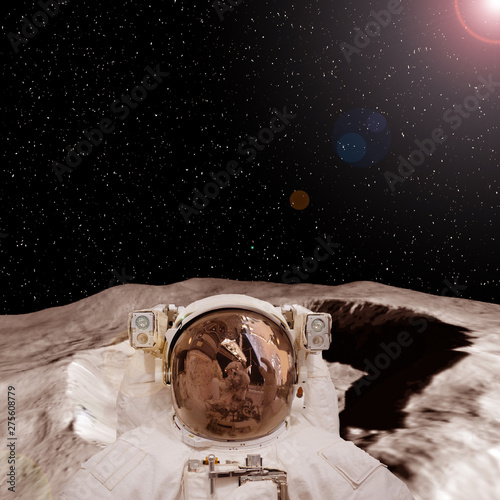Fototapeta Naklejka Na Ścianę i Meble -  Astronaut on the extrasolar planet. Strange stony landscape on the background. The elements of this image furnished by NASA.