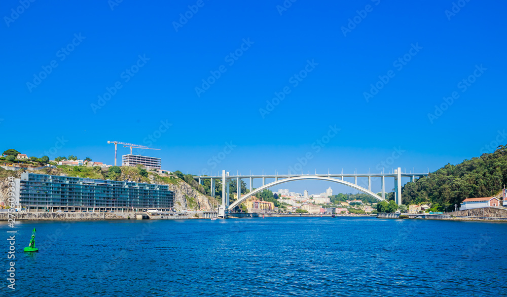 Naklejka premium Arrabida Bridge in Porto Portugal, crossing the Douro River and linking Porto with Vila Nova de Gaia