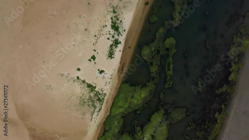 Aerial, rising, drone shot top down, above the coast of Culburra Beach, on a sunny evening, in New South Wales, Australia photo