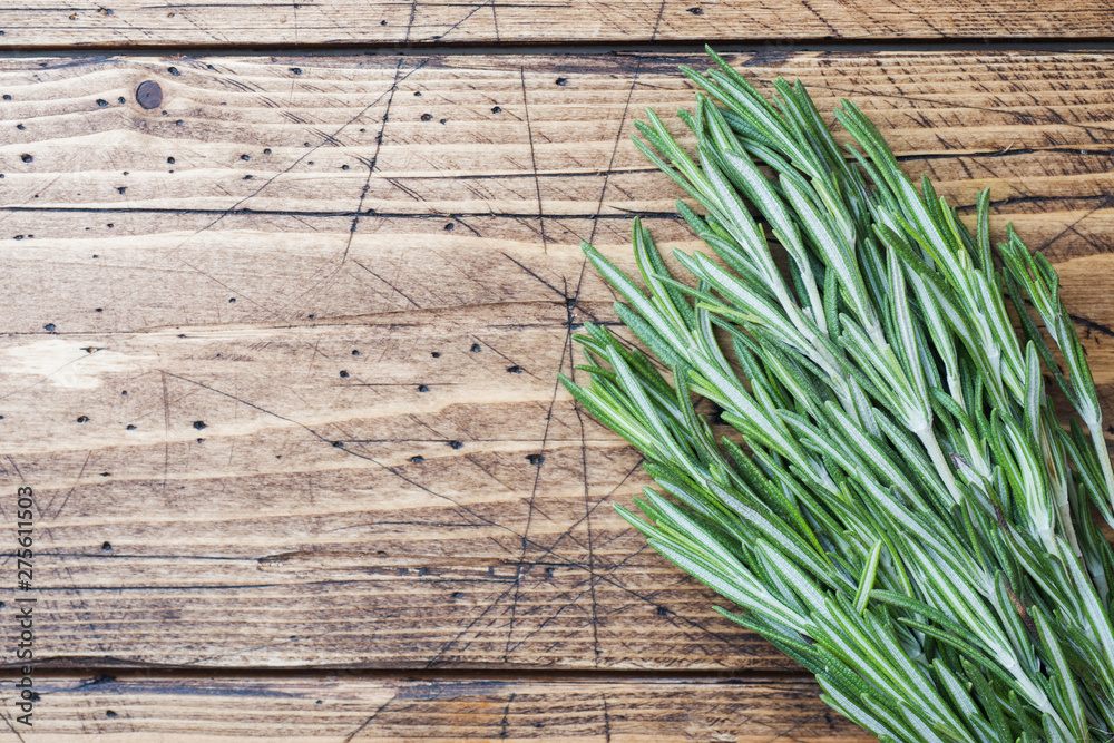 Bunch of fresh rosemary on wooden background. Copy space. Bunch of fresh rosemary on wooden background. Copy space.