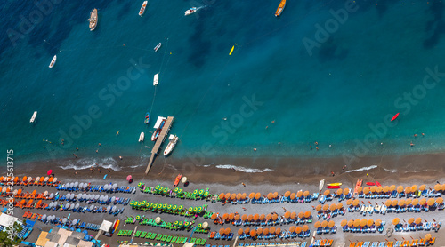 Aerial View of Positano Beach. Beautiful cliff view of Positano beach at daytime, with its beach umbrellas. Amalfi coast situated in province of Salerno, in the region of Campania, Italy. © Paulo