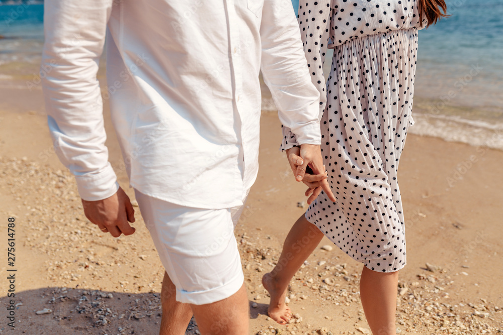 Love - romantic couple holding hands on a beach in sunset. - Love - romantic couple holding hands on a beach in sunset. -