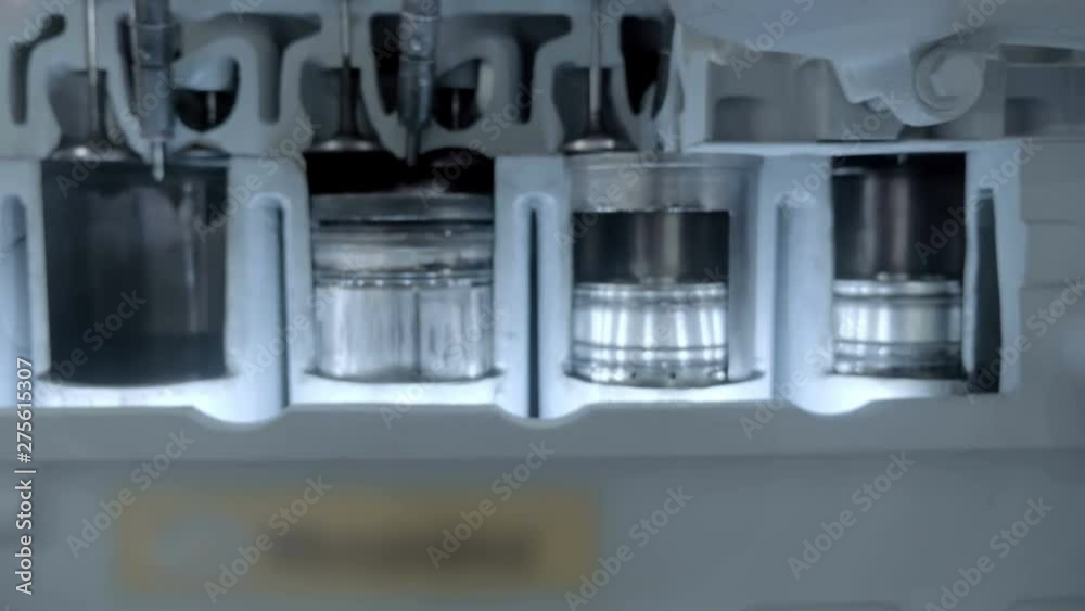 The movement of the cylinders of the internal combustion engine are visible on the sample with a cutting in the cylinder block. Shot in motion