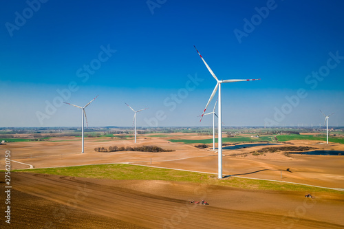 Wind turbines in spring on field, aerial view of Poland